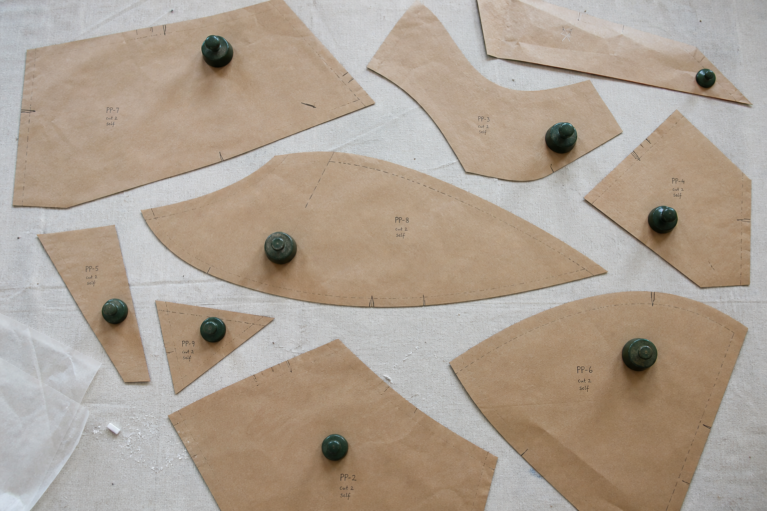 Pattern pieces on cutting floor representing service structure